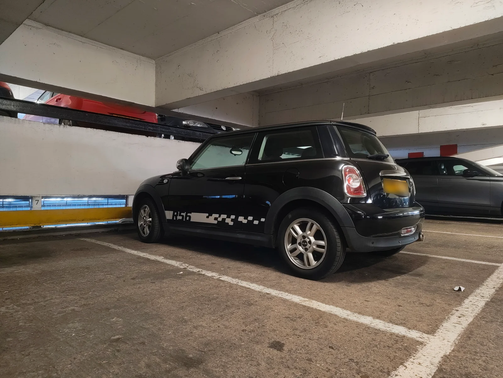 Black MINI R56 with side graphics in a multistorey car park