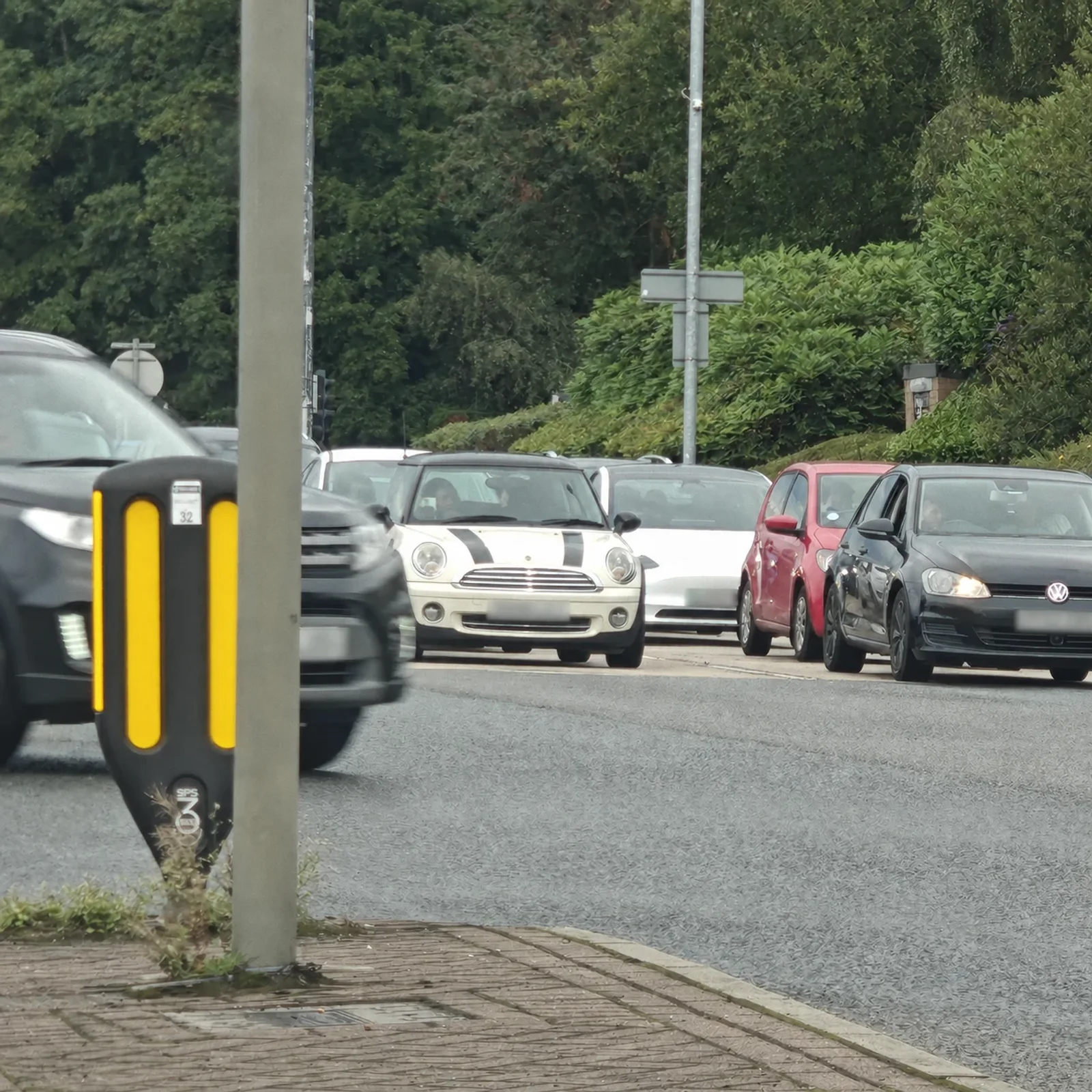 Cream MINI R56 waiting across a junction