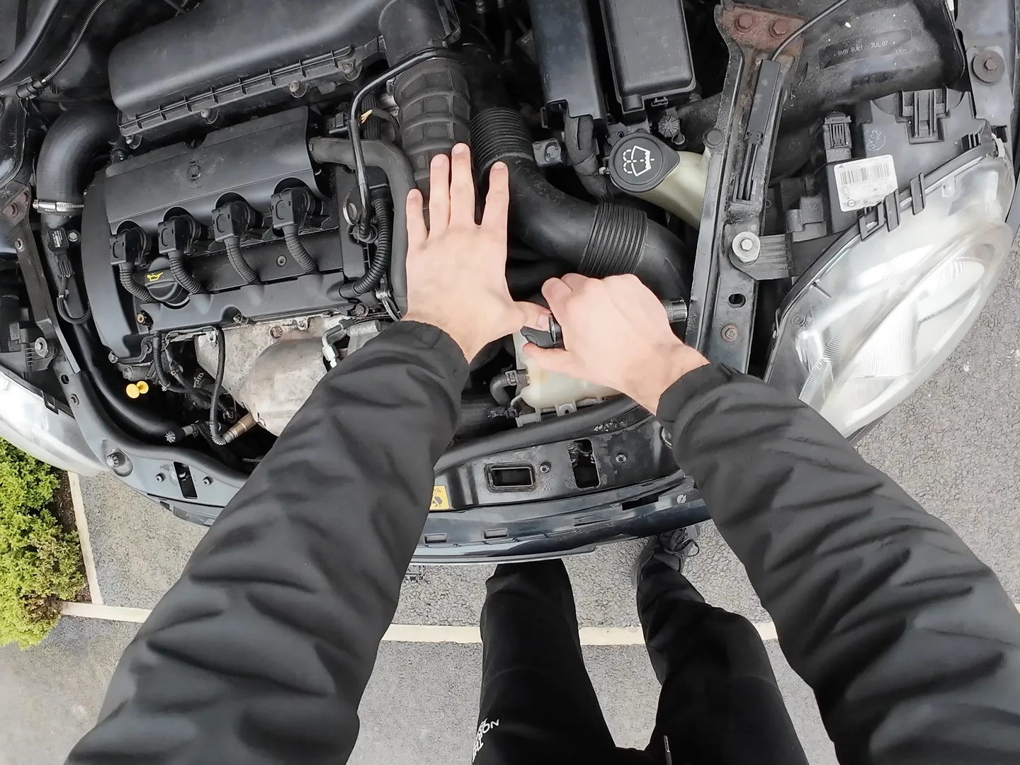 Holding down coolant reservoir cap