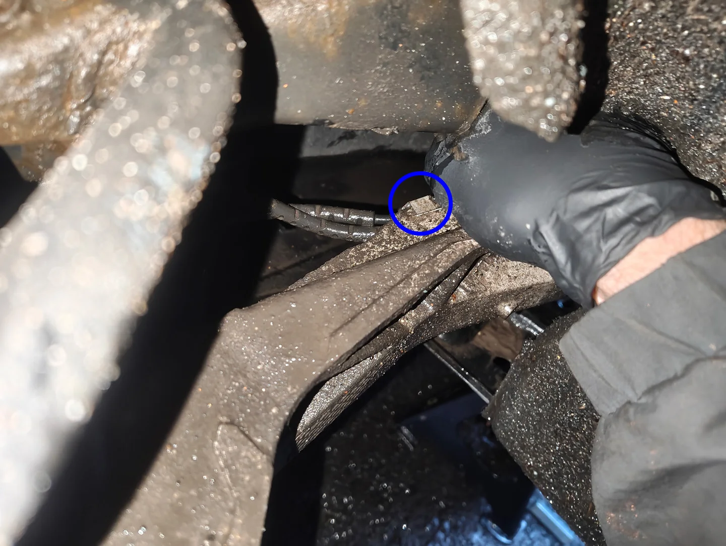 Metal clip securing brake pad sensor