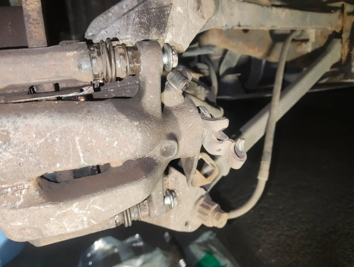Partially installed brake caliper fixing bolts
