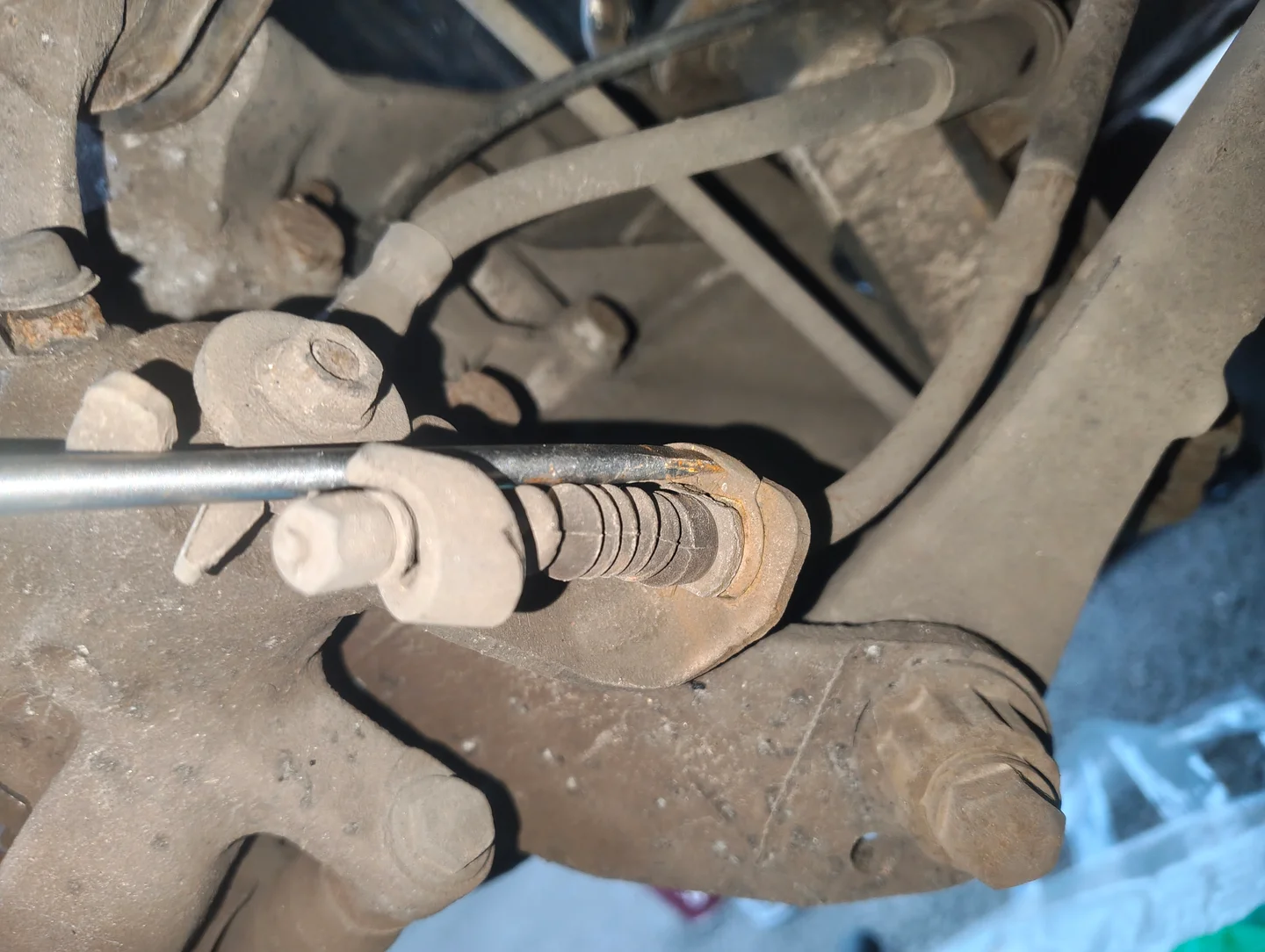 Prying parking brake cable retaining clip