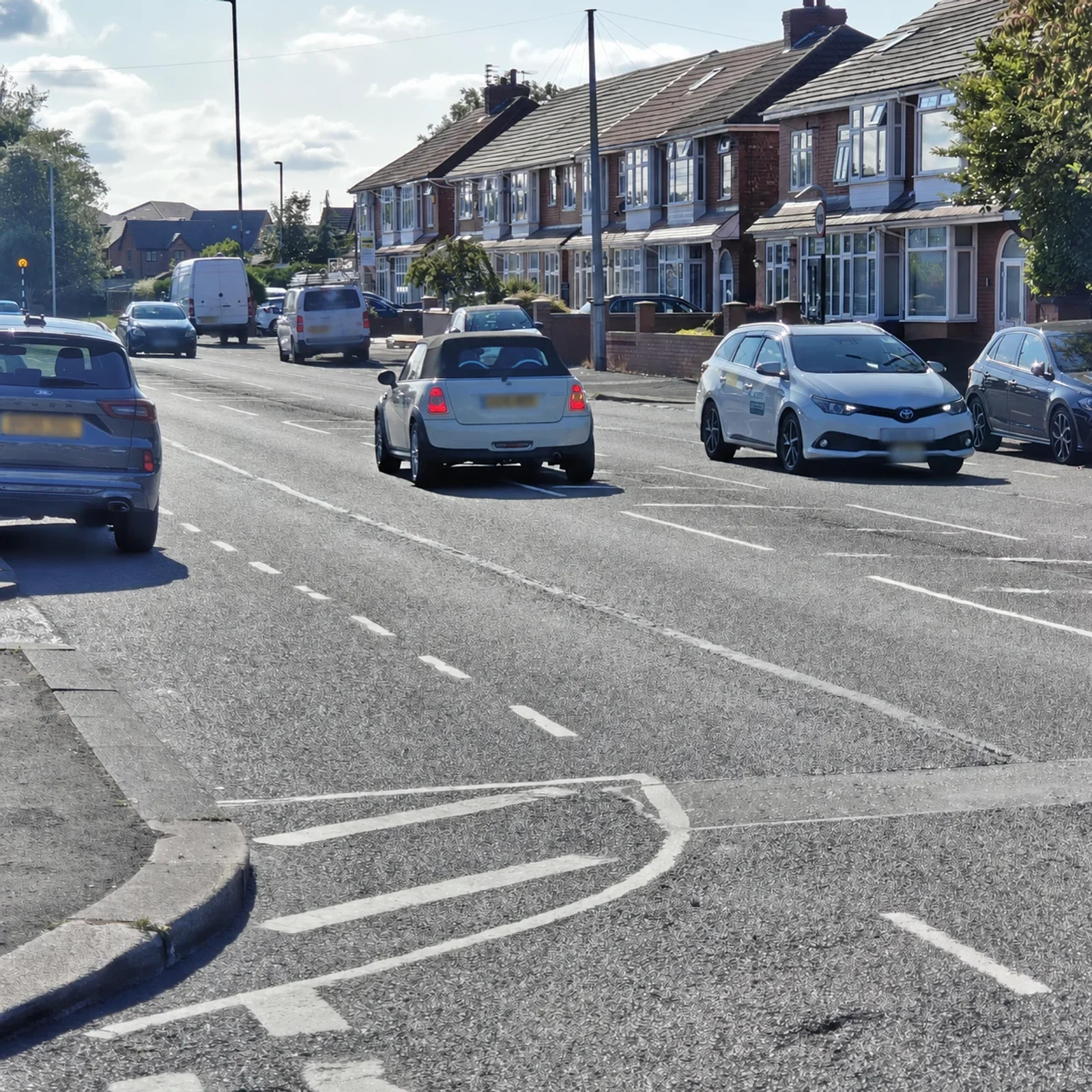 Silver MINI R56 driving along a residential street