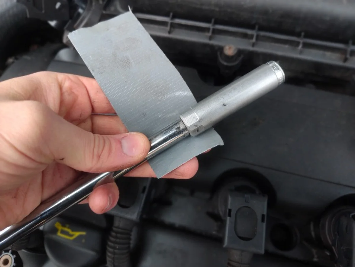 Taping spark plug socket to extension