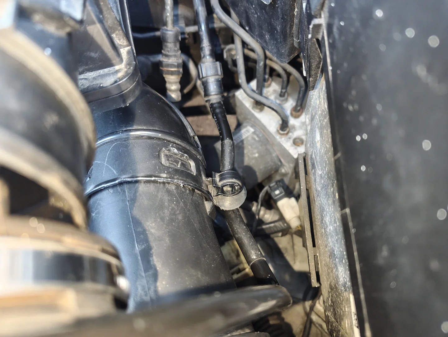 Unclipped vacuum line from air intake duct