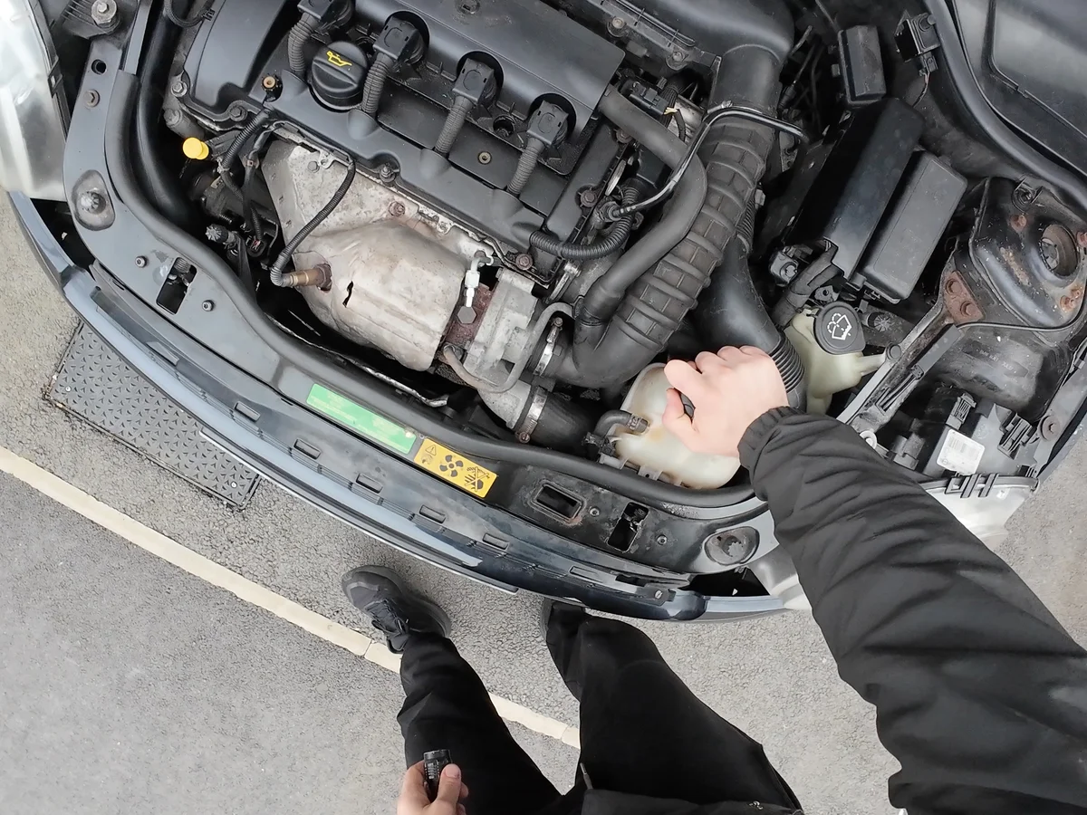 Unscrewing coolant reservoir cap