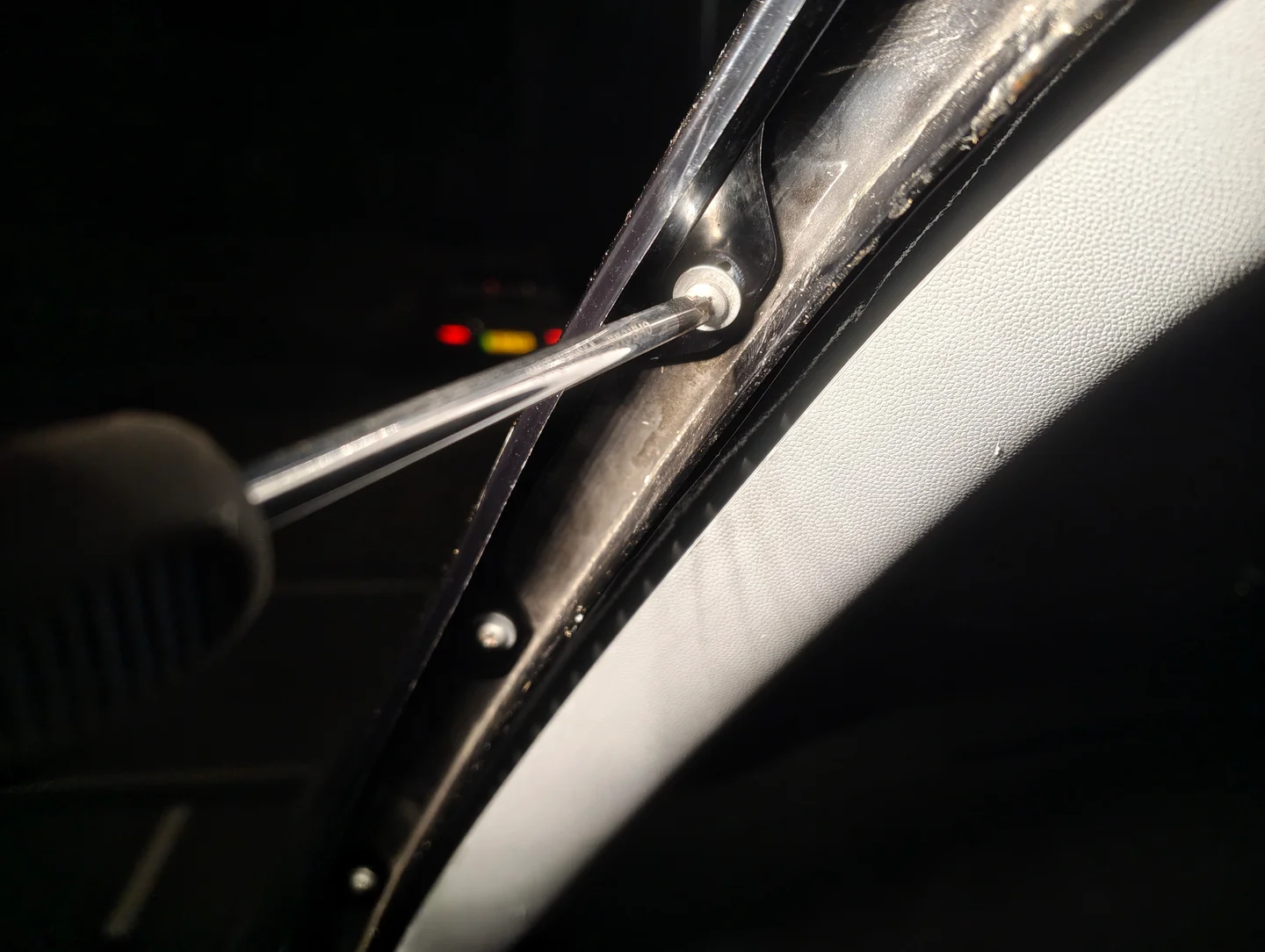 Unscrewing nearside A-Pillar screws